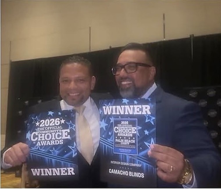 Two Camacho Blinds representatives holding the 2026 Community's Choice Awards winner plaques for Interior Design Company